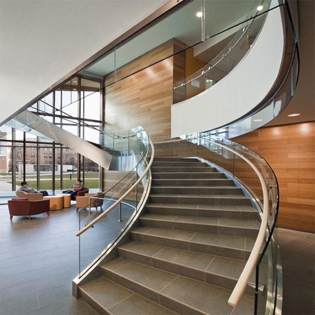 Modern steel arc curved staircase with marble treads